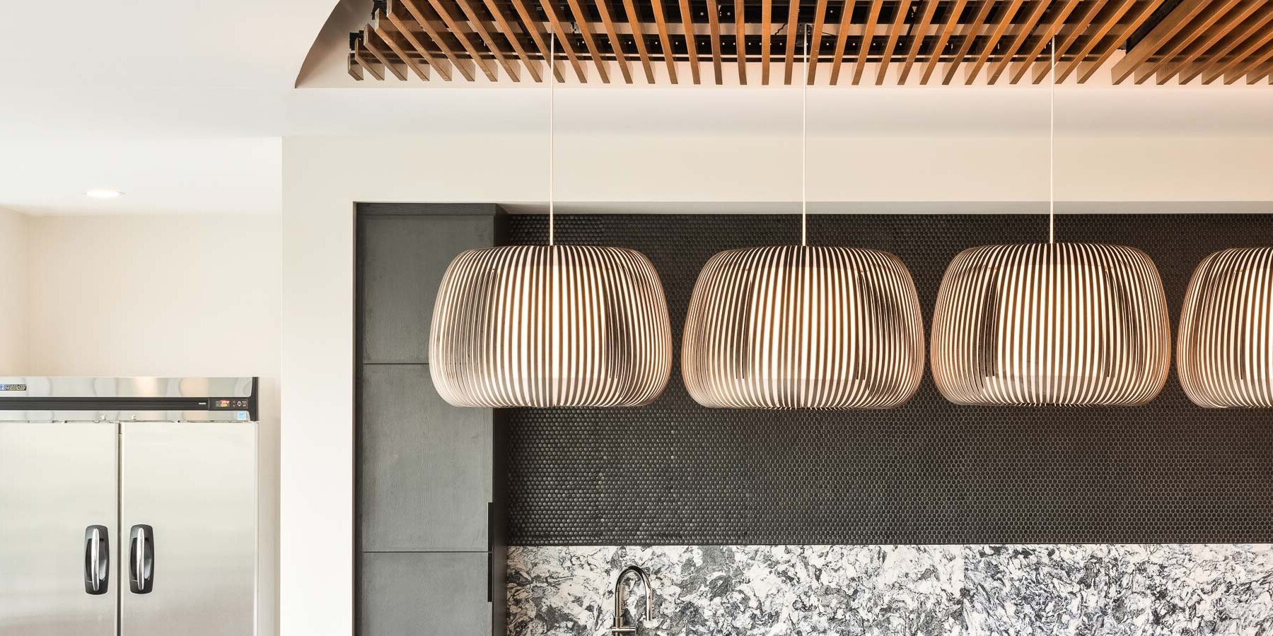Decorative pendant lighting at round room's bar area